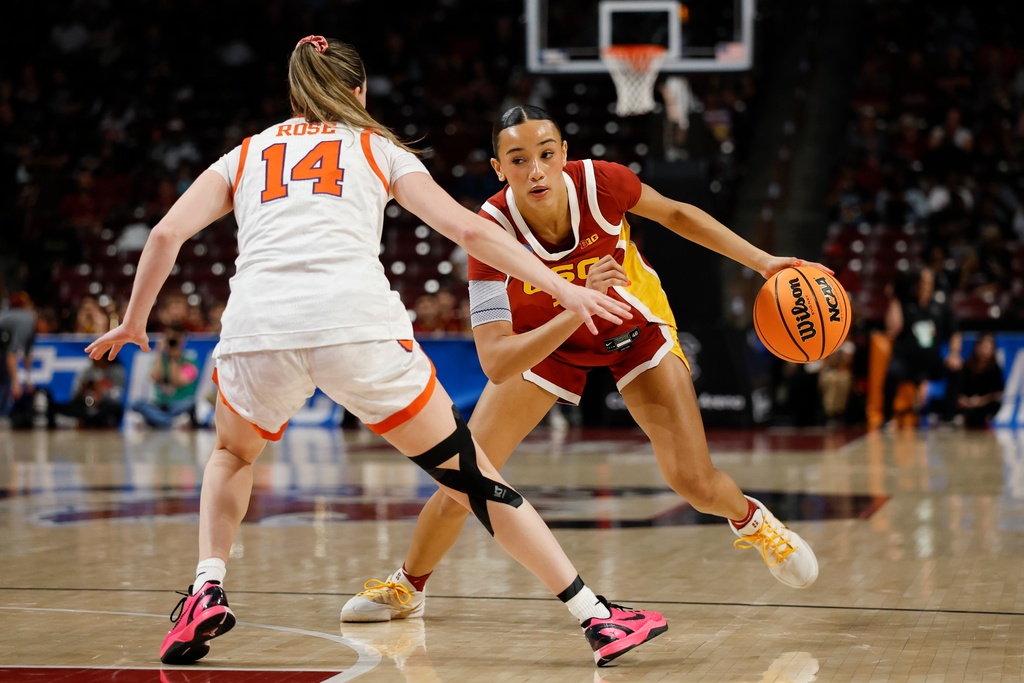Southern California guard Jazzy Davidson, right, drives against Clemson guard Rachael Rose (14) during the first half of the first round of the NCAA college basketball tournament, Saturday, March 21, 2026, in Columbia, S.C. (AP Photo/Nell Redmond)