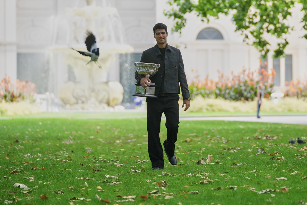 Carlos Alcaraz of Spain holds the Norman Brookes Challenge Cup the morning after defeating Novak Djokovic of Serbia in the men's singles final at the Australian Open tennis championship, in Melbourne, Australia, Monday, Feb. 2, 2026. (AP Photo/Dita Alangkara)