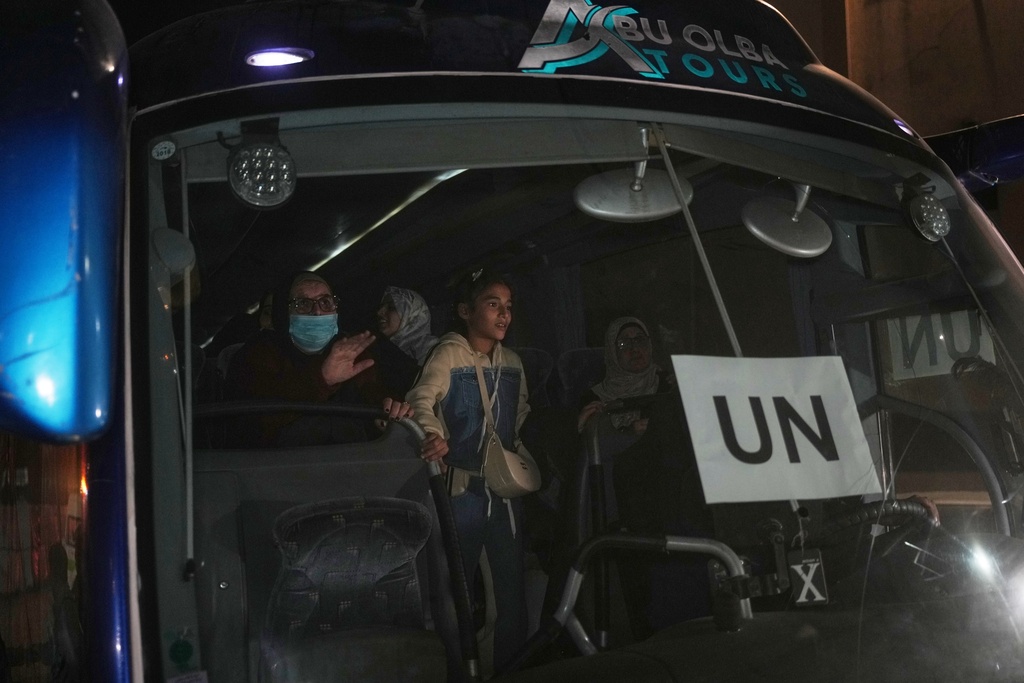 Returnees arrive in a bus at Nasser Hospital after a group of 12 Palestinians was allowed into Gaza from Egypt following the long-awaited reopening of the Rafah border crossing, which was marred by delays, in Khan Younis, southern Gaza Strip, early Tuesday, Feb. 3, 2026. (AP Photo/Abdel Kareem Hana)