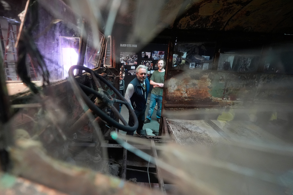 Eric Pirone looks into Ken Kesey's psychedelic bus "Furthur" where it will be displayed at the Forever Grateful exhibit presented by the Haight Street Art Center at the County Fair Building in Golden Gate Park, Tuesday, Sept. 1, 2026, in San Francisco. (AP Photo/Jeff Chiu)