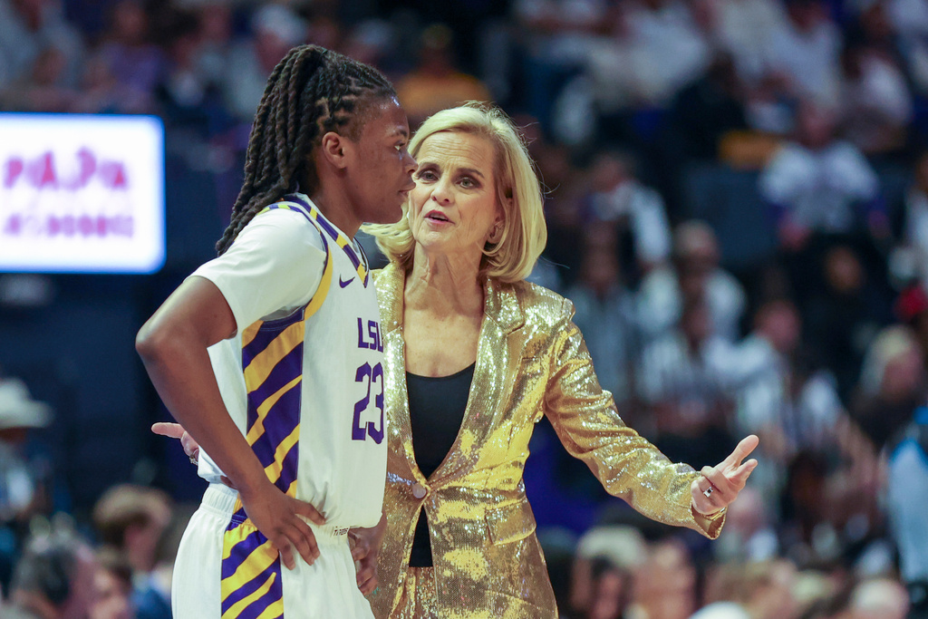 LSU head coach Kim Mulkey, right, talks to guard MiLaysia Fulwiley (23) in the second half of an NCAA college basketball game against Texas in Baton Rouge, La., Sunday, Jan. 11, 2026. (AP Photo/Peter Forest)