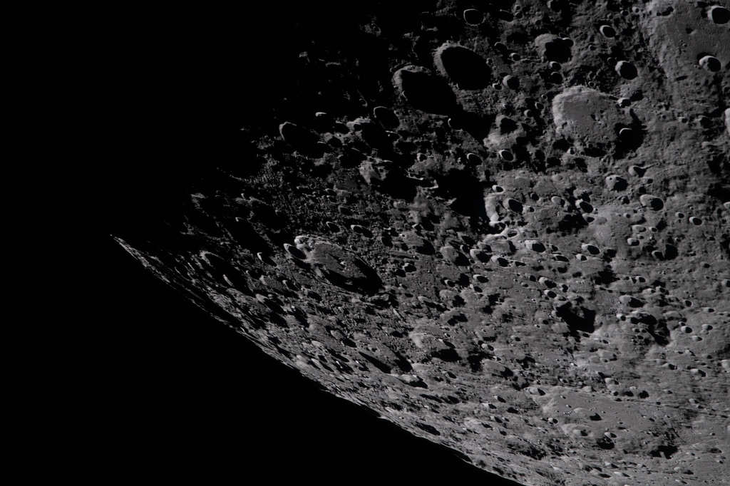 In this image provided by NASA, the Artemis II crew captured this image of the heavily cratered terrain of the eastern edge of the South Pole-Aitken basin of the Moon with the shadowed terminator – the boundary between lunar day and night during a lunar flyby, Monday, April 6, 2026. NASA via AP)