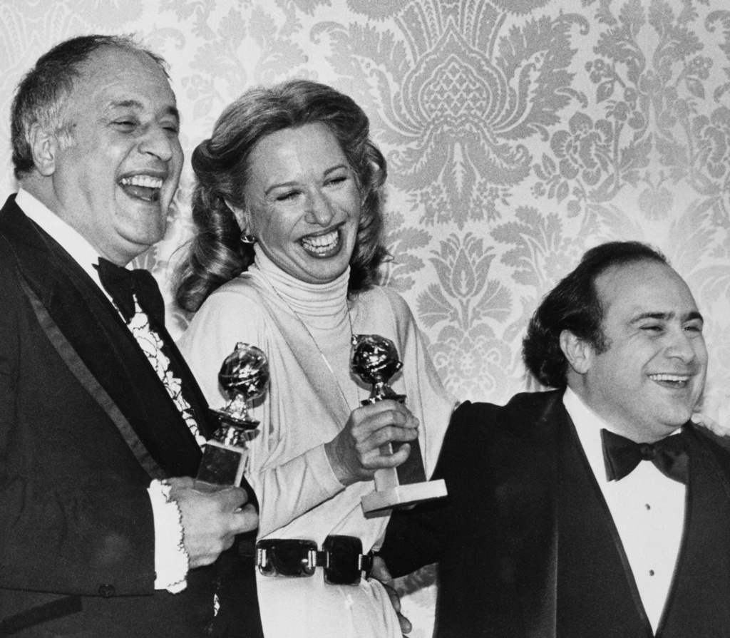 FILE - Actors Polly Holliday, center, and Vic Tayback, left, appear with actor Danny DeVito after receiving their Golden Globe awards in Beverly Hills, Calif., on Jan. 26, 1980. (AP Photo/George Brich, File)