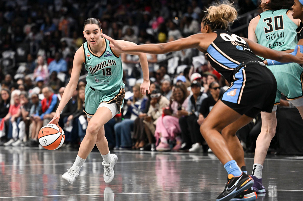New York guard Pauline Astier (18) drives to the basket against Atlanta forward Naz Hillmon (00) during the first half in Game 2 of the WNBA basketball semifinals, Wednesday, Oct. 7, 2026, in Atlanta. (AP Photo/Daniel Varnado)