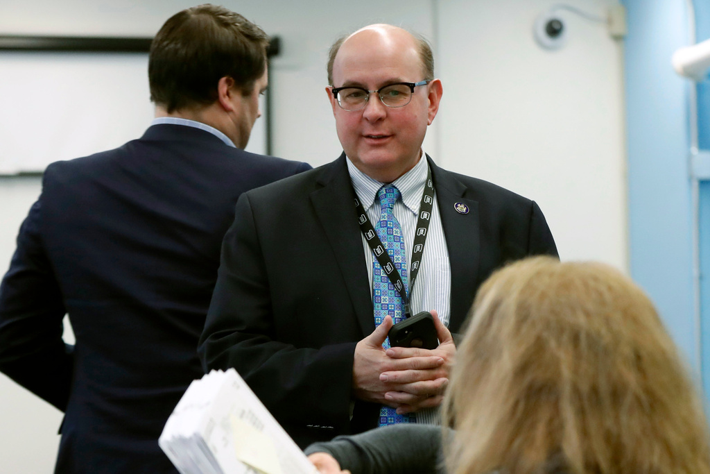 FILE - Maine Secretary of State Matt Dunlap oversees the recounting of ballots in the state's 2nd Congressional District, in Augusta, Maine, Dec. 6, 2018. (AP Photo/Robert F. Bukaty, File)