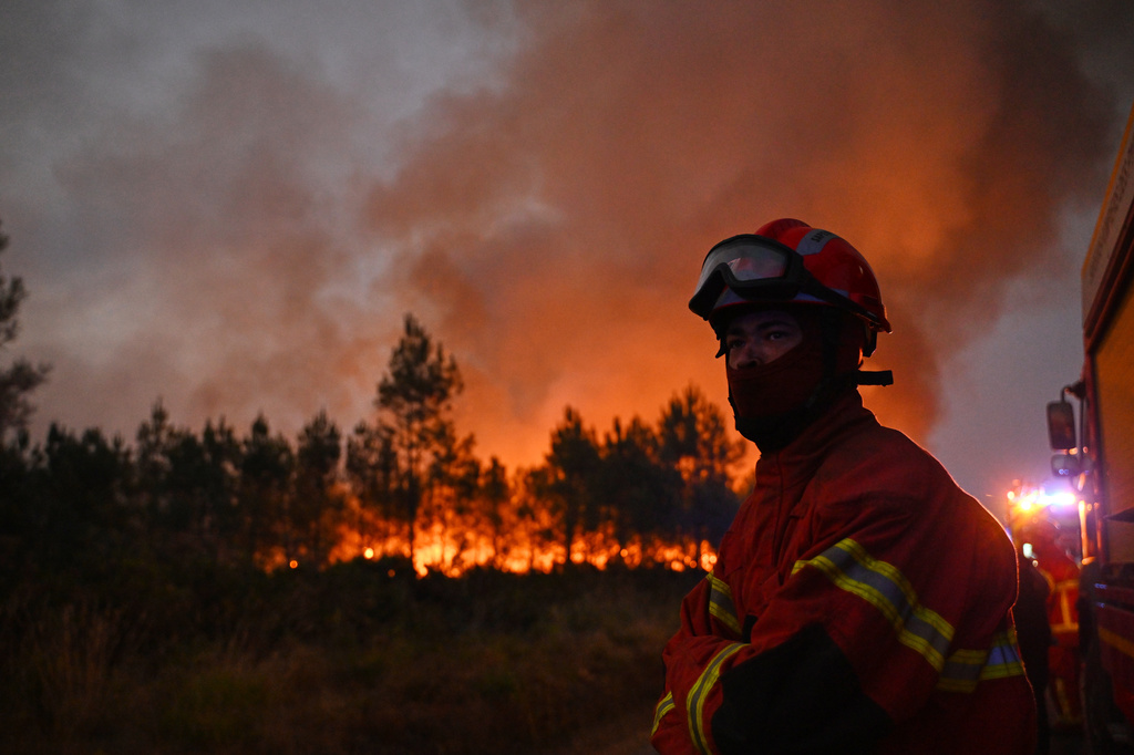 Firefighters battle a blaze outside Lanton, during wildfires in southwestern France, Tuesday, July 28, 2026. (AP Photo/Emma Da Silva)