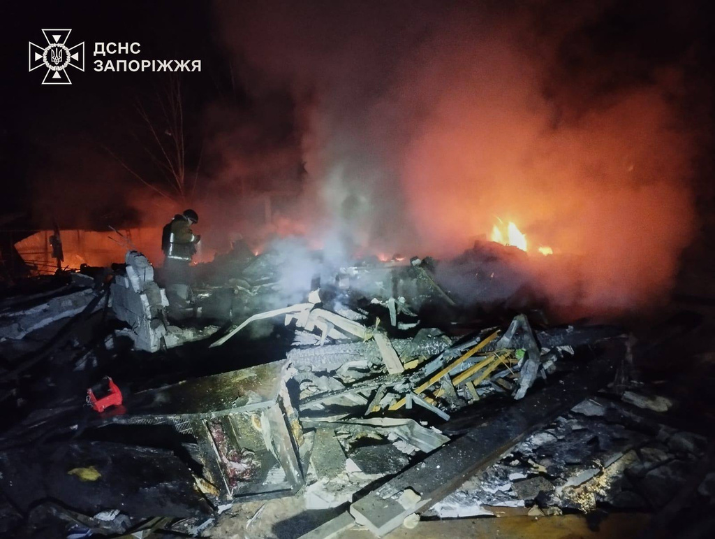 In this photo provided by the Ukrainian Emergency Service, emergency services personnel work to extinguish a fire following a Russian attack in Zaporizhzhia region, Ukraine, Thursday, Jan. 29, 2026. (Ukrainian Emergency Service via AP)