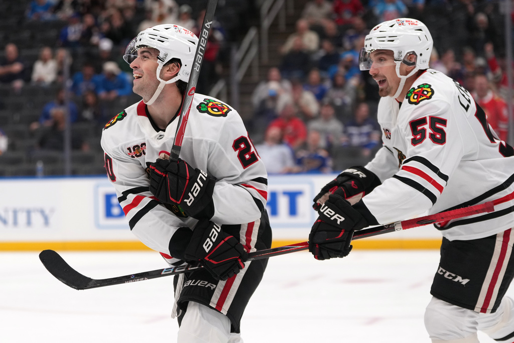 Chicago Blackhawks' Ryan Greene (20) is congratulated by Artyom Levshunov (55) after scoring during the third period of an NHL hockey game against the St. Louis Blues Wednesday, Oct. 15, 2025, in St. Louis. (AP Photo/Jeff Roberson)