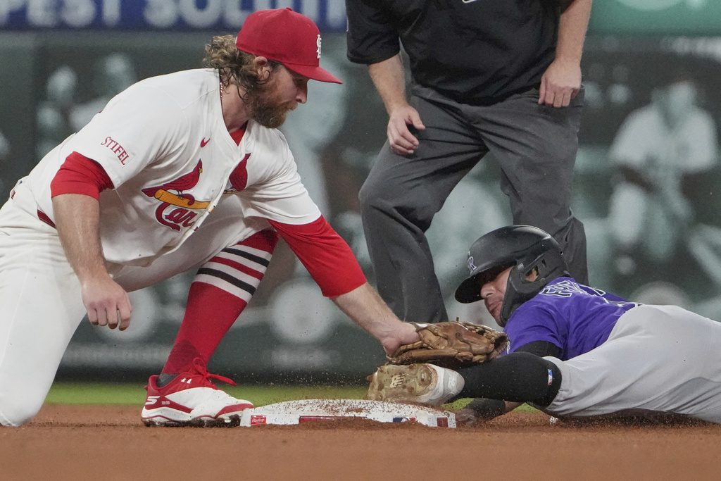 Colorado Rockies' Tyler Freeman, right, is out as he slides past the bag while trying to steal second as St. Louis Cardinals second baseman Brendan Donovan makes the tag during the fourth inning of a baseball game Tuesday, Aug. 12, 2025, in St. Louis. (AP Photo/Jeff Roberson)