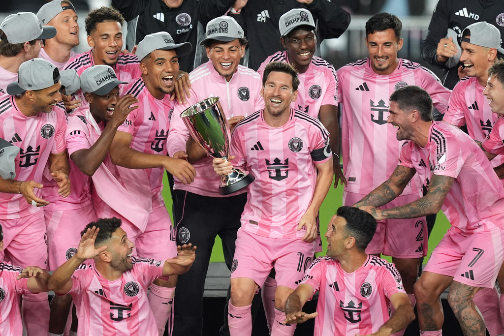 Inter Miami forward Lionel Messi (10) holds the trophy as Inter Miami players celebrate winning an MLS Eastern Conference final soccer match against New York City FC, Saturday, Nov. 29, 2025, in Fort Lauderdale, Fla. (AP Photo/Rebecca Blackwell)