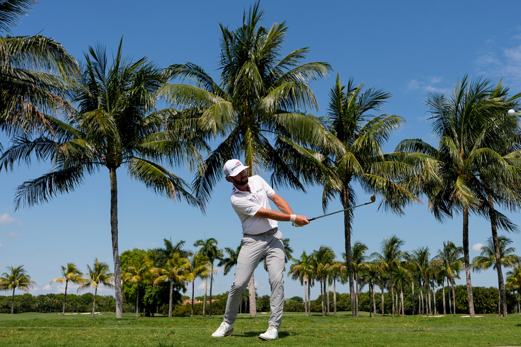 Cameron Young hits along the cart path on the first fairway during the first round of the Cadillac Championship PGA golf tournament Thursday, April 30, 2026, in Doral, Fla. (AP Photo/David J. Phillip)