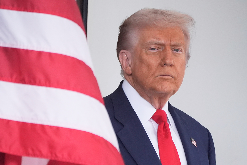 President Donald Trump waits to greet Argentina's President Javier Milei, as he arrives at the White House, Tuesday, Oct. 14, 2025, in Washington. (AP Photo/Mark Schiefelbein)