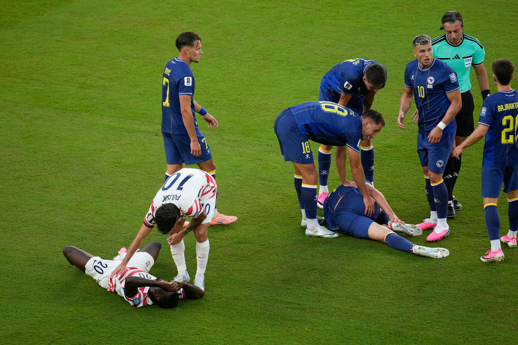 United States' Folarin Balogun (20) lays on the pitch after a foul against Bosnia's Tarik Muharemovic (4) during the World Cup round of 32 soccer match between the United States and Bosnia in Santa Clara, Calif., near San Francisco, Wednesday, July 1, 2026. Balogun received a red card on the play. (AP Photo/Jeff Chiu)
