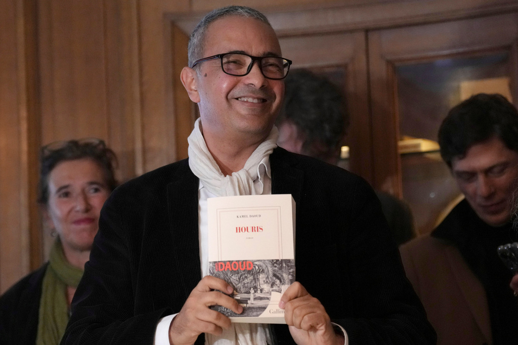 FILE - Algerian-French novelist Kamel Daoud holds his book Houris after being awarded with the Goncourt, France's most prestigious literary prize, Monday, Nov. 4, 2024 in Paris. (AP Photo/Aurelien Morissard, File)