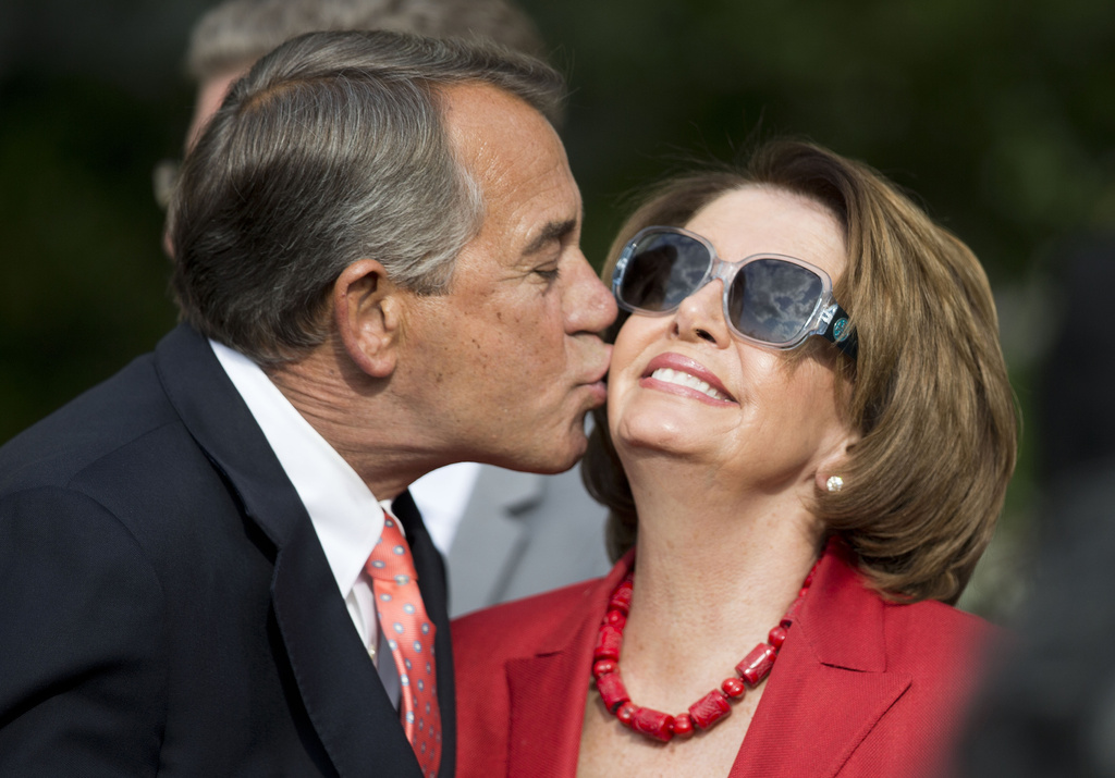 FILE - House Speaker John Boehner of Ohio, left, kisses House Minority Leader Nancy Pelosi of Calif., right, in the Rose Garden of the White House before President Barack Obama's remarks to members of Congress, April 21, 2015 in Washington. (AP Photo/Pablo Martinez Monsivais, File)