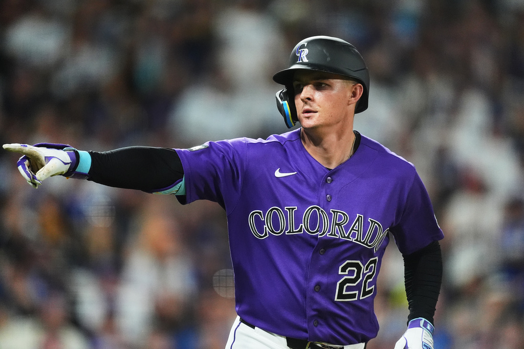 Colorado Rockies' Mickey Moniak gestures to the dugout as he heads up the first-base line after connecting for a two-run home run off Los Angeles Dodgers relief pitcher Alex Vesia in the seventh inning of a baseball game Wednesday, Aug. 19, 2026, in Denver. (AP Photo/David Zalubowski)