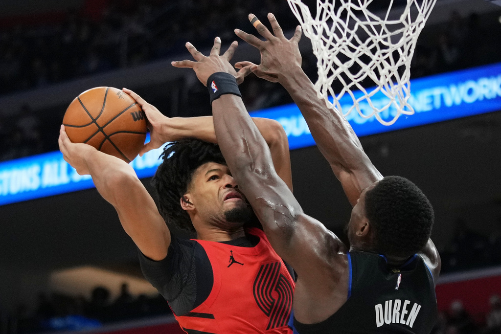 Portland Trail Blazers guard Shaedon Sharpe, left, drives against Detroit Pistons center Jalen Duren during the first half of an NBA basketball game, Friday, Dec. 5, 2025, in Detroit. (AP Photo/Ryan Sun)
