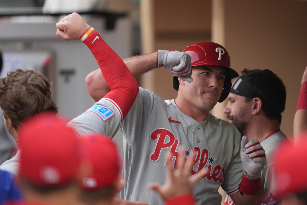 Philadelphia Phillies' J.T. Realmuto, right, celebrates with teammates after hitting a home run during the second inning of a baseball game against the San Diego Padres Tuesday, May 26, 2026, in San Diego. (AP Photo/Gregory Bull)