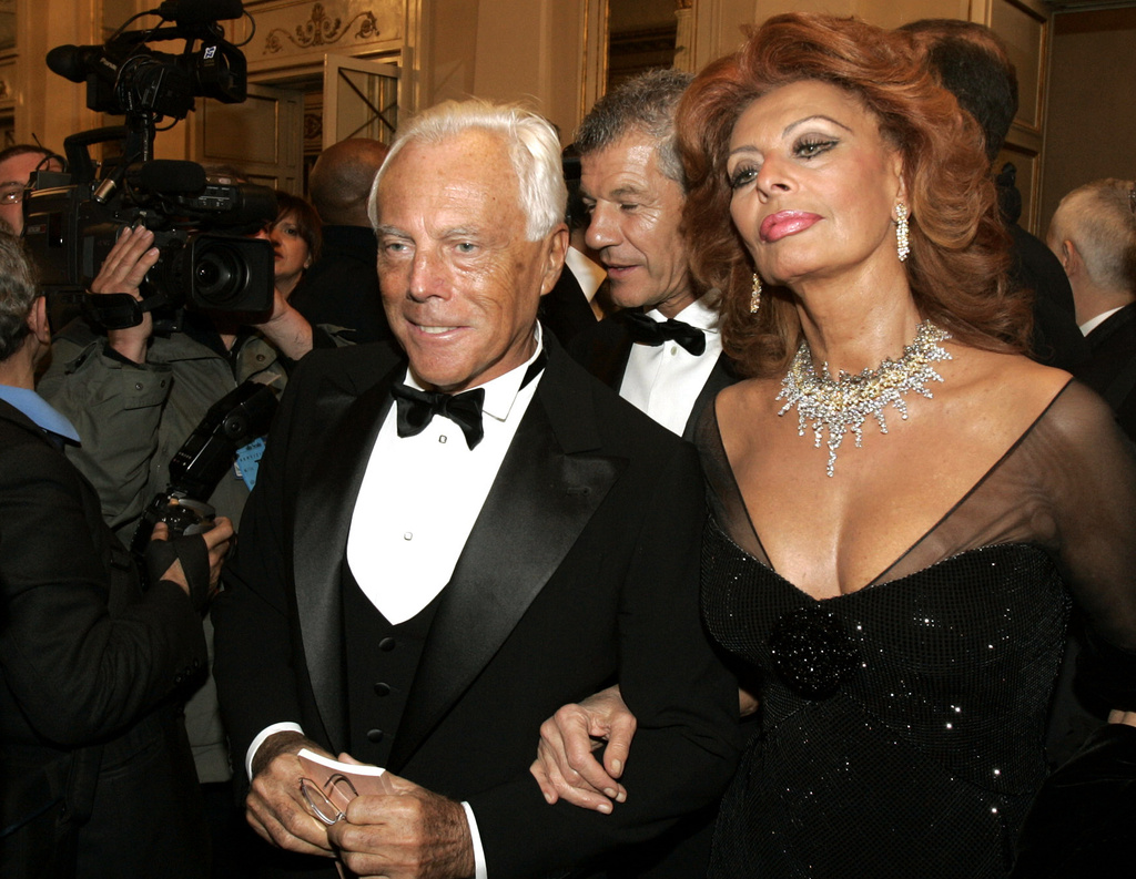 FILE - Italian actress Sophia Loren, right, and fashion designer Giorgio Armani arrive for the reopening of La Scala theater in Milan, Dec. 7, 2004. (AP Photo/Luca Bruno, File)