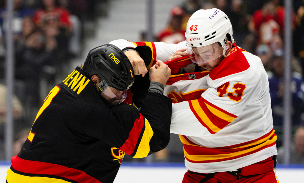 Vancouver Canucks' Luke Schenn (2) and Calgary Flames' Adam Klapka (43) fight during the first period of an NHL hockey game in Vancouver, British Columbia, Saturday, Oct. 3, 2026. (Jacob Mallari/The Canadian Press via AP)