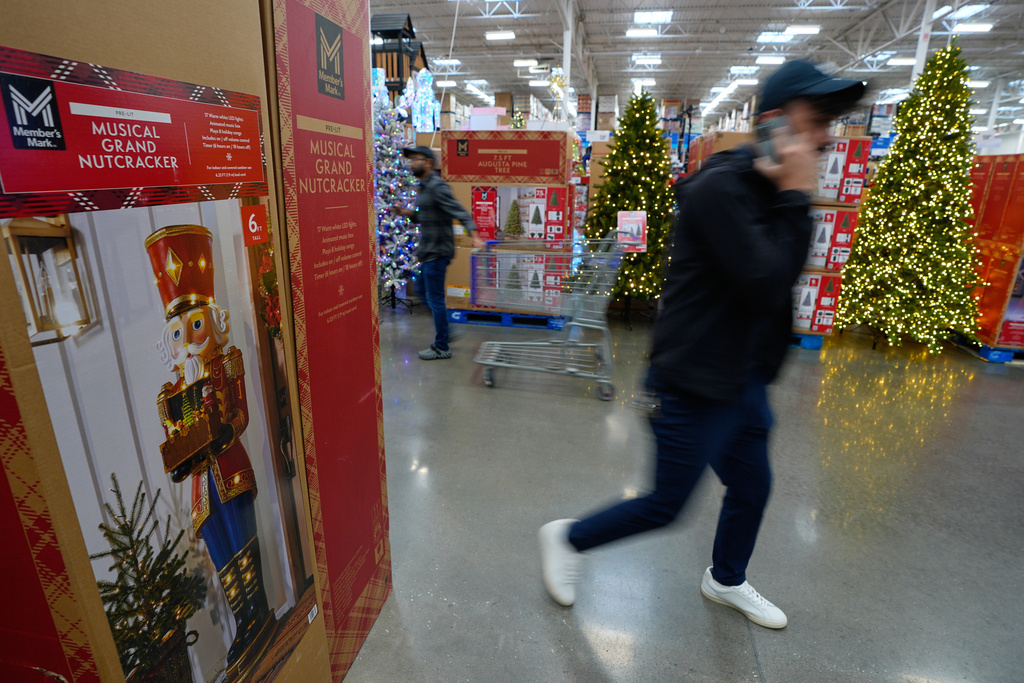 People shop among holiday displays at a Sam's Club, Wednesday, Sept. 24, 2025, in Bentonville, Ark. (AP Photo/Charlie Riedel)