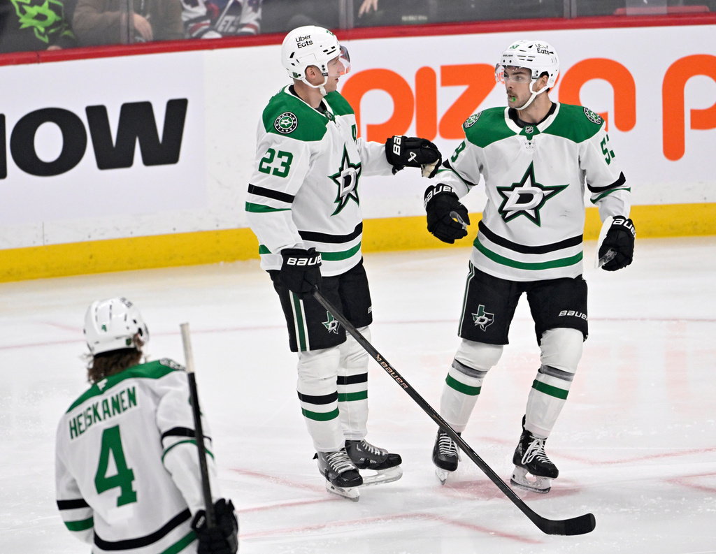 Dallas Stars' Esa Lindell (23) celebrates his goal on the Winnipeg Jets with Wyatt Johnston, right, during the first period of an NHL hockey game in Winnipeg, Manitoba, Tuesday, Dec. 9, 2025. (Fred Greenslade/The Canadian Press via AP)