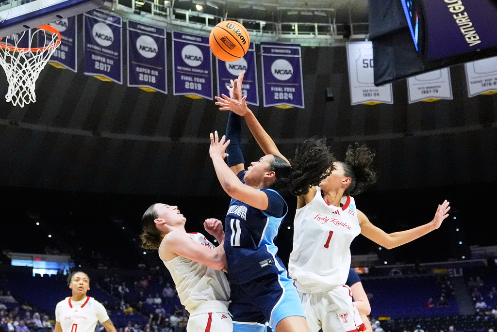 Villanova guard Jasmine Bascoe (11) shoots between Texas Tech guard Bailey Maupin and forward Jalynn Bristow (1) during the first half in the first round of the NCAA college basketball tournament, Friday, March 20, 2026, in Baton Rouge, La. (AP Photo/Gerald Herbert)