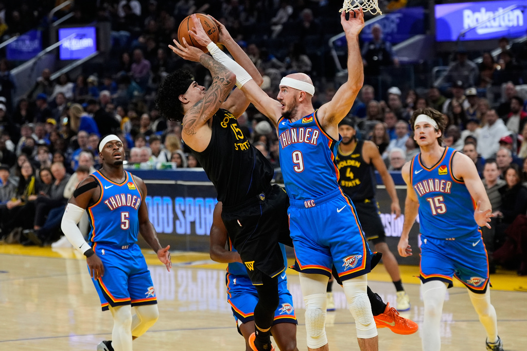 Golden State Warriors forward Gui Santos (15) is fouled by Oklahoma City Thunder guard Alex Caruso (9) during the first half of an NBA basketball game, Friday, Jan. 2, 2026, in San Francisco. (AP Photo/Godofredo A. Vásquez)