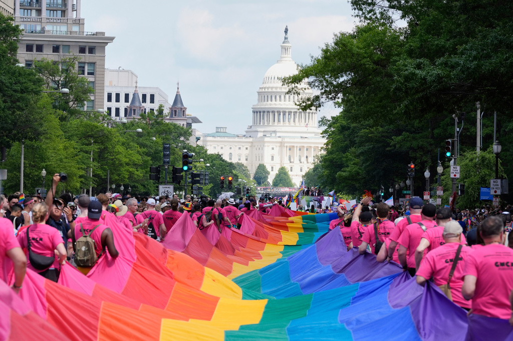 FILE - Participants carry a large pride flag during the World Pride parade with the U.S. Capitol in the background, June 7, 2025, in Washington. (AP Photo/Mark Schiefelbein, file)
