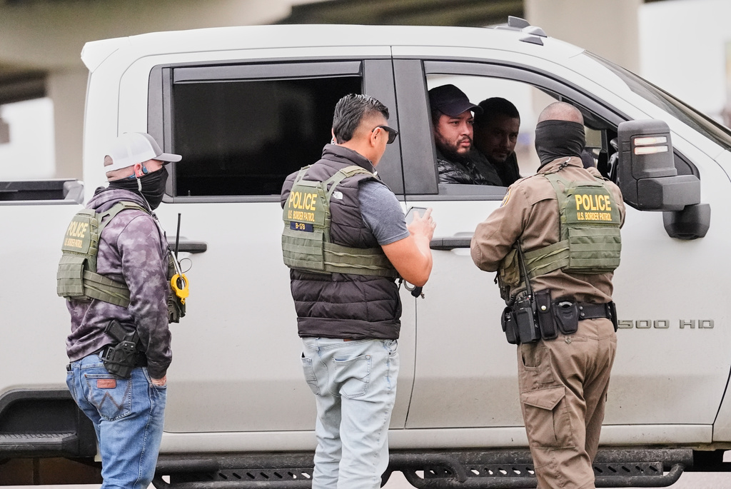 FILE - Customs and Border Patrol agents question occupants of a vehicle they pulled over, during an immigration crackdown in Kenner, La., Dec. 5, 2025. (AP Photo/Gerald Herbert, File)