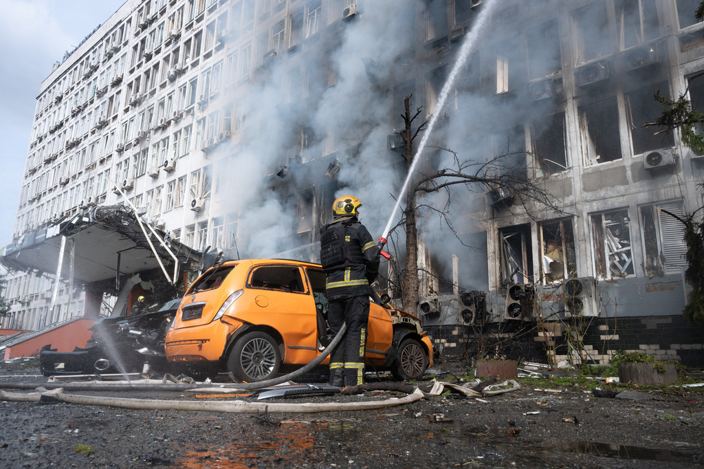 Firefighters extinguish a fire at a burning building following a Russian drone strike in Kyiv, Ukraine, Wednesday, Sept. 23, 2026. (AP Photo/Danylo Antoniuk)
