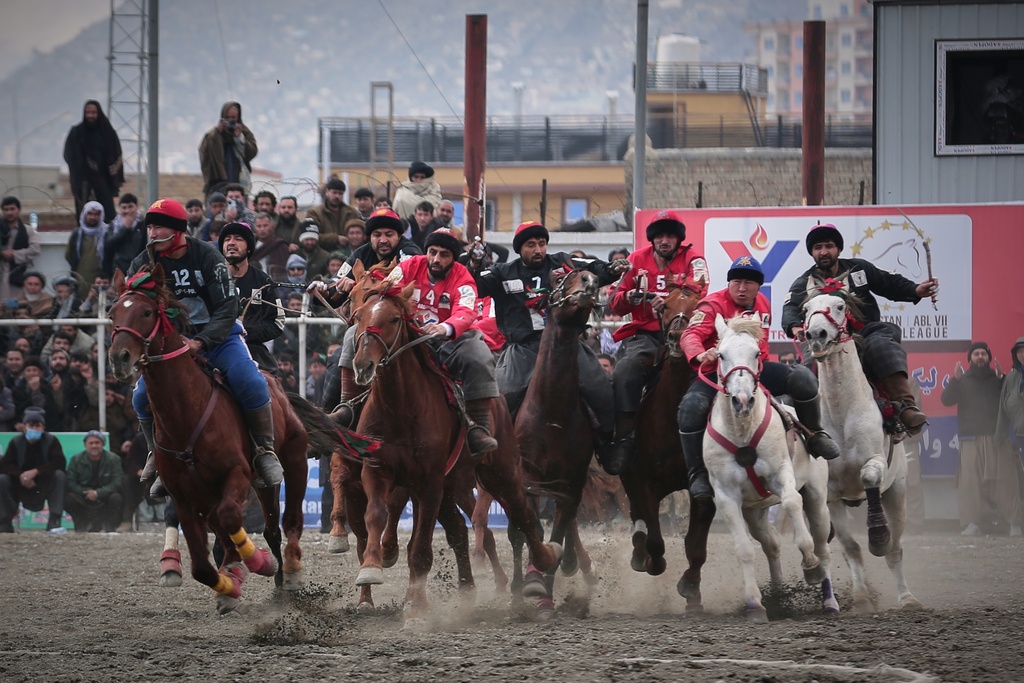 Riders from the Sar-e-Pul and Badakhshan compete in the final of Afghanistan's annual buzkashi tournament, a traditional equestrian sport in which riders score points using a fake goat carcass, on the outskirts of Kabul, Afghanistan, Monday, Dec. 22, 2025. (AP Photo)