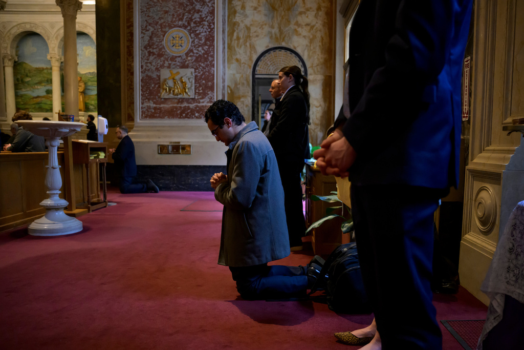 A parishioner kneels during prayer, during an Ash Wednesday Mass at the Cathedral of St. Matthew the Apostle, Wednesday, Feb., 18, 2026, in Washington. (AP Photo/Rod Lamkey, Jr.)
