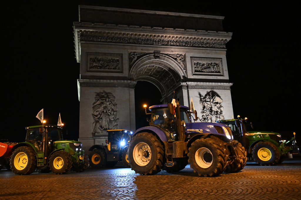 Farmers drive their tractors past the Arc de Triomphe as they protest the Mercosur trade deal, Tuesday, Jan. 13, 2026 in Paris. (AP Photo/Emma Da Silva)