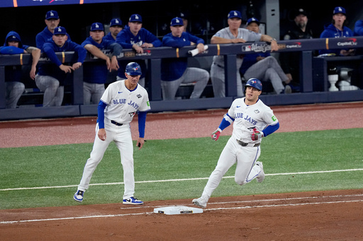 Toronto Blue Jays' Daulton Varsho runs past the Los Angeles Dodgers dugout after hitting his two run home run during the fourth inning in Game 1 of baseball's World Series, Friday, Oct. 24, 2025, in Toronto. (AP Photo/David J. Phillip) Toronto Blue Jays' Daulton Varsho runs past the Los Angeles Dodgers dugout after hitting his two run home run during the fourth inning in Game 1 of baseball's World Series, Friday, Oct. 24, 2025, in Toronto. (AP Photo/David J. Phillip)