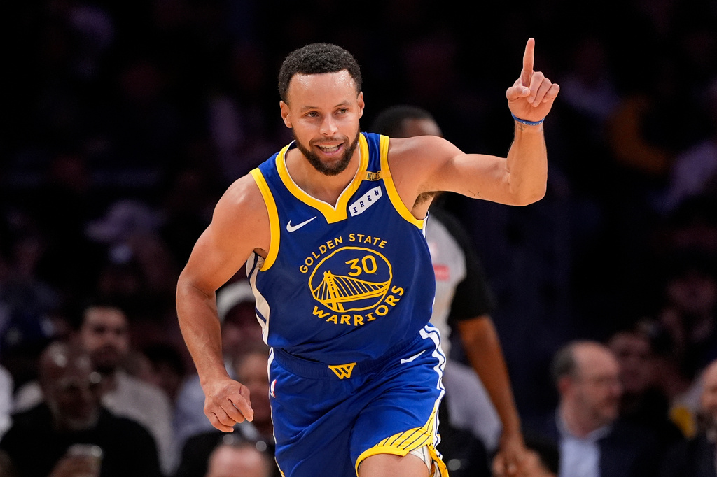Golden State Warriors guard Stephen Curry gestures after scoring during the first half of an NBA basketball game against the Los Angeles Lakers, Wednesday, Oct. 21, 2026, in Los Angeles. (AP Photo/Mark J. Terrill)