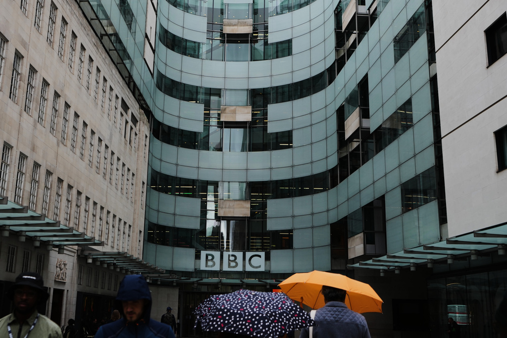 People walk outside BBC Broadcasting House in London, Tuesday, Nov. 11, 2025. (AP Photo/Kirsty Wigglesworth)