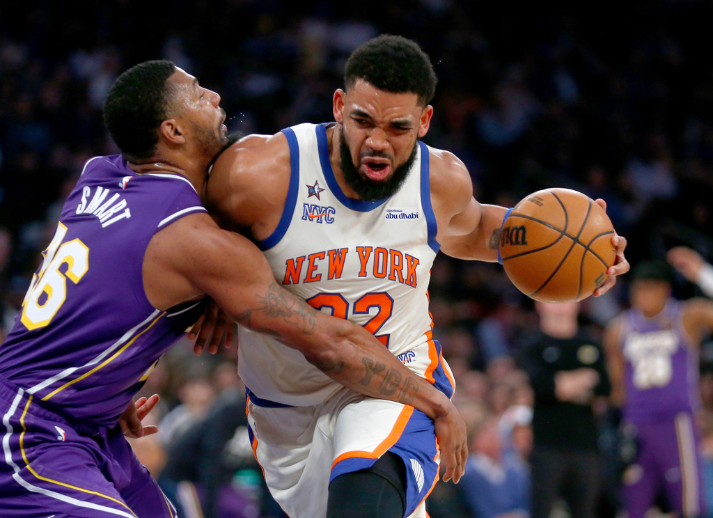 Los Angeles Lakers guard Marcus Smart, left, defends against New York Knicks center Karl-Anthony Towns, right, during the first half of an NBA basketball game, Sunday, Feb. 1, 2026, in New York. (AP Photo/John Munson)