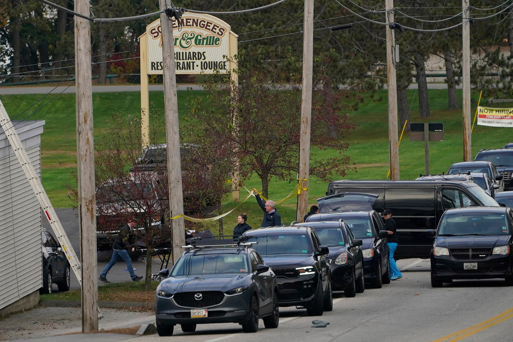 FILE - A body is wheeled out on a stretcher at Schemengees Bar and Grille, Oct. 26, 2023, in Lewiston, Maine. (AP Photo/Robert F. Bukaty, File)