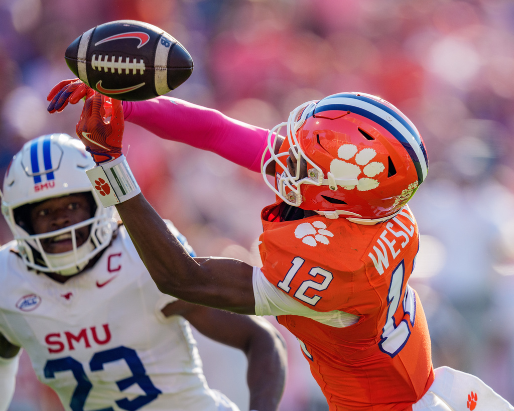 Clemson wide receiver Bryant Wesco Jr. (12) drops a pass while covered by SMU safety Isaiah Nwokobia (23) in the first half of an NCAA college football game Saturday, Oct. 18, 2025, in Clemson, S.C. (AP Photo/Jacob Kupferman)