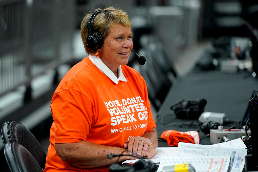 FILE - Ann Meyers Drysdale prepares her court-side broadcast prior to a Phoenix Mercury basketball game, June 3, 2022, in Phoenix. (AP Photo/Matt York, File)