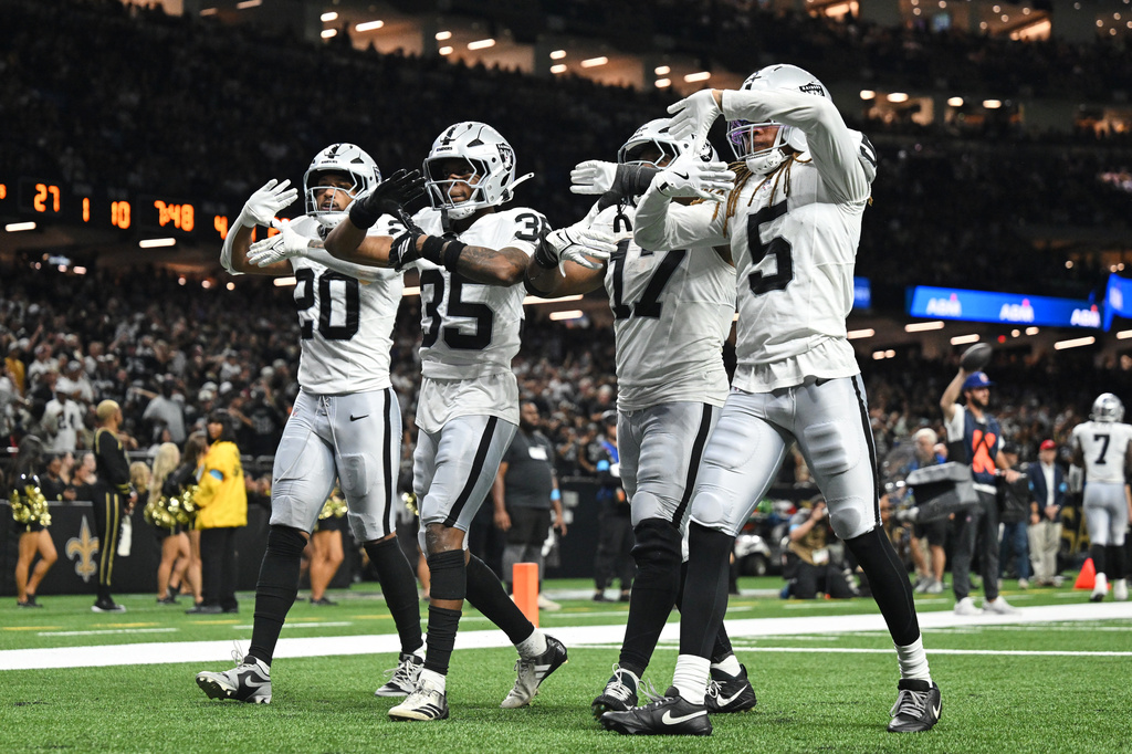 Las Vegas Raiders' Isaiah Pola-Mao (20), Hezekiah Masses (35), Nakobe Dean (17) and Eric Stokes (5) celebrate after Masses intercepted a New Orleans Saints pass during the second half of an NFL football game in New Orleans, Sunday, Sept. 27, 2026. (AP Photo/Ella Hall)