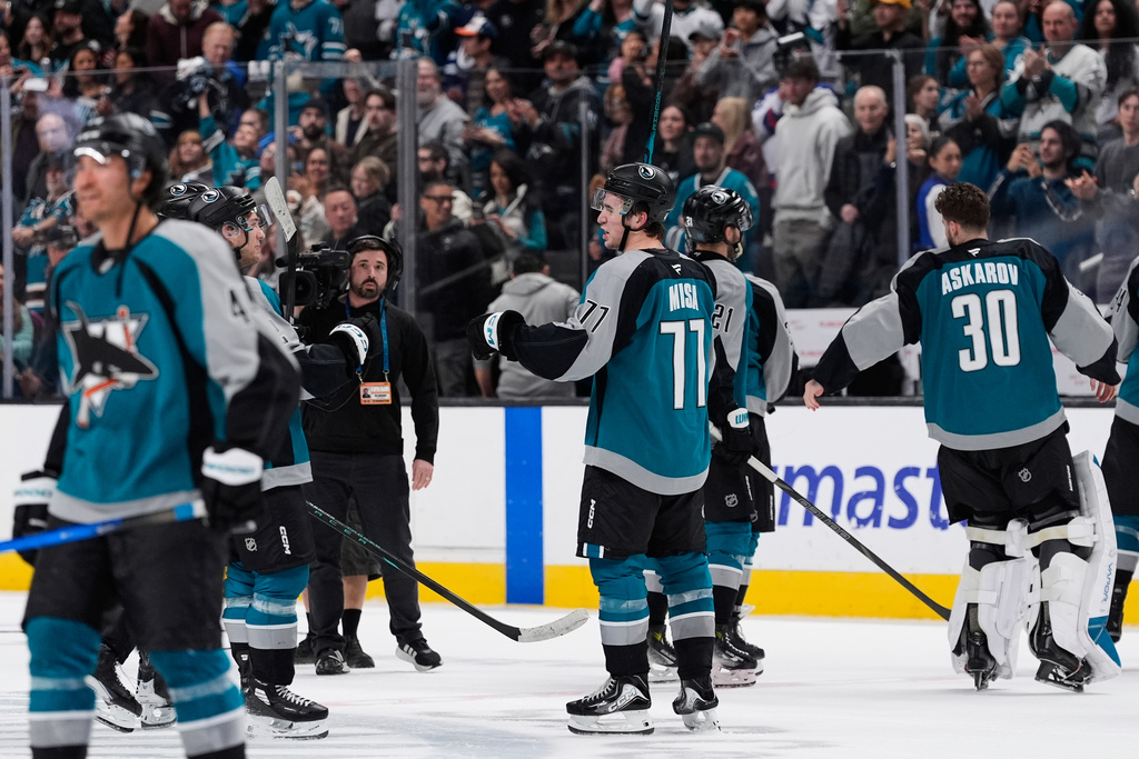 San Jose Sharks center Michael Misa (77) celebrates with teammates after scoring the game-winning goal during overtime of an NHL hockey game against the Winnipeg Jets, Sunday, March 1, 2026, in San Jose, Calif. (AP Photo/Godofredo A. Vásquez)