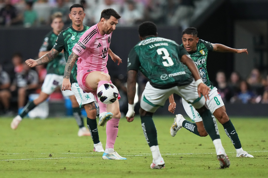 Inter Miami forward Leo Messi, left controls the ball as Club León forward Juan Domínguez (8) defends during the second half of a Leagues Cup soccer match, Wednesday, Aug. 12, 2026, in Miami. (AP Photo/Lynne Sladky)