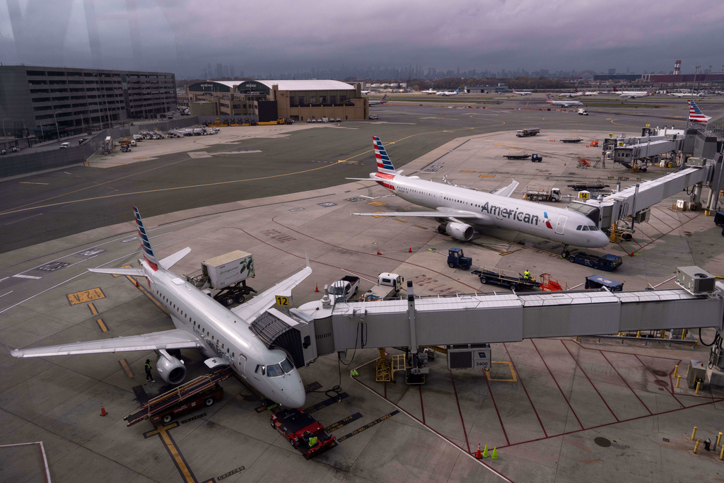 American Eagle and American Airlines planes sit at gates at LaGuardia Airport (LGA), in the Queens borough of New York, Sunday, Nov. 9, 2025. (AP Photo/Adam Gray)