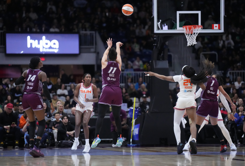 Toronto Tempo guard Kia Nurse (11) takes a 3 point shot against the Connecticut Sun during first half pre-season WNBA basketball game in Toronto, Wednesday, April 29, 2026. (Nathan Denette/The Canadian Press via AP)