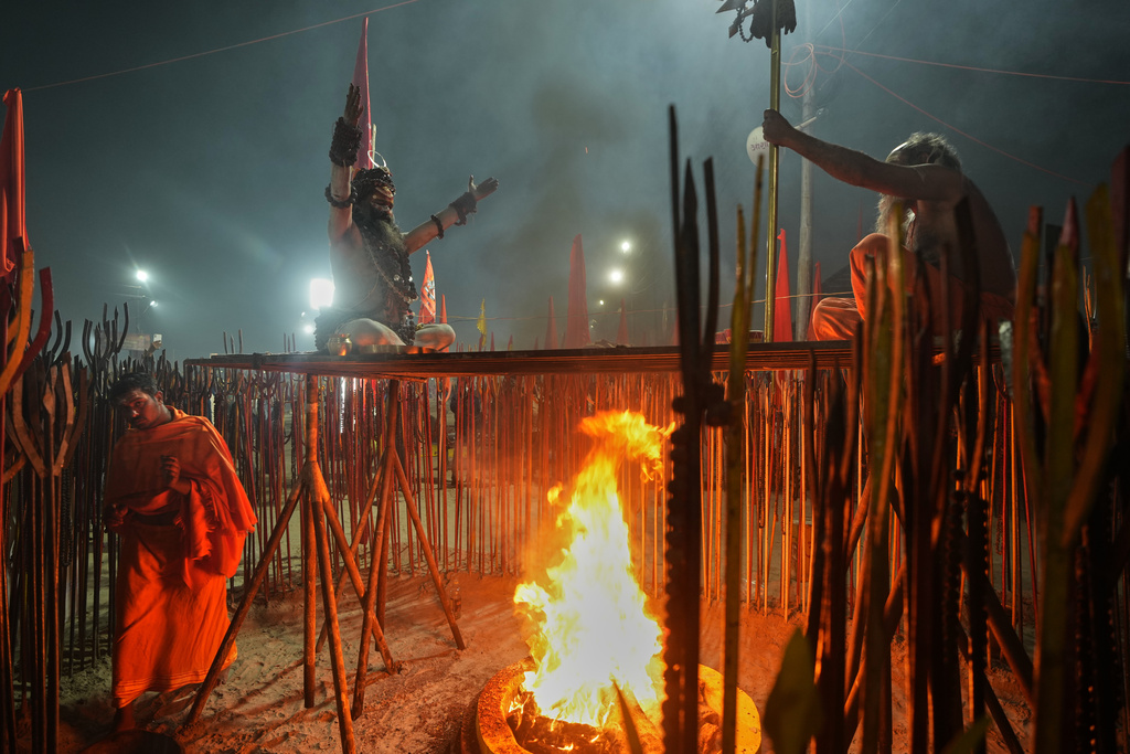 Hindu holy men pray on the eve of Mauni Amavasya, a divine occasion in Hindu religious practice followed for honoring ancestors or forefathers, at the Sangam, the confluence of the Ganges, the Yamuna and the mythical Saraswati rivers, during the annual month long Hindu religious fair "Magh Mela" in Prayagraj, India, Saturday, Jan.17, 2026. (AP Photo/Rajesh Kumar Singh)