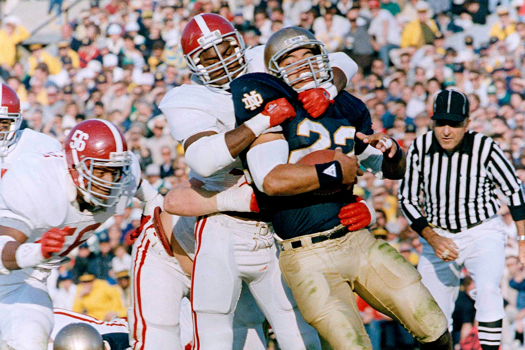 FILE - Notre Dame's Anthony Johnson (22) is stopped by Alabama's Derrick Thomas during the first quarter of an NCAA college football game in South Bend, Ind., Nov. 14, 1987. (AP Photo/Tom Strattman, File)