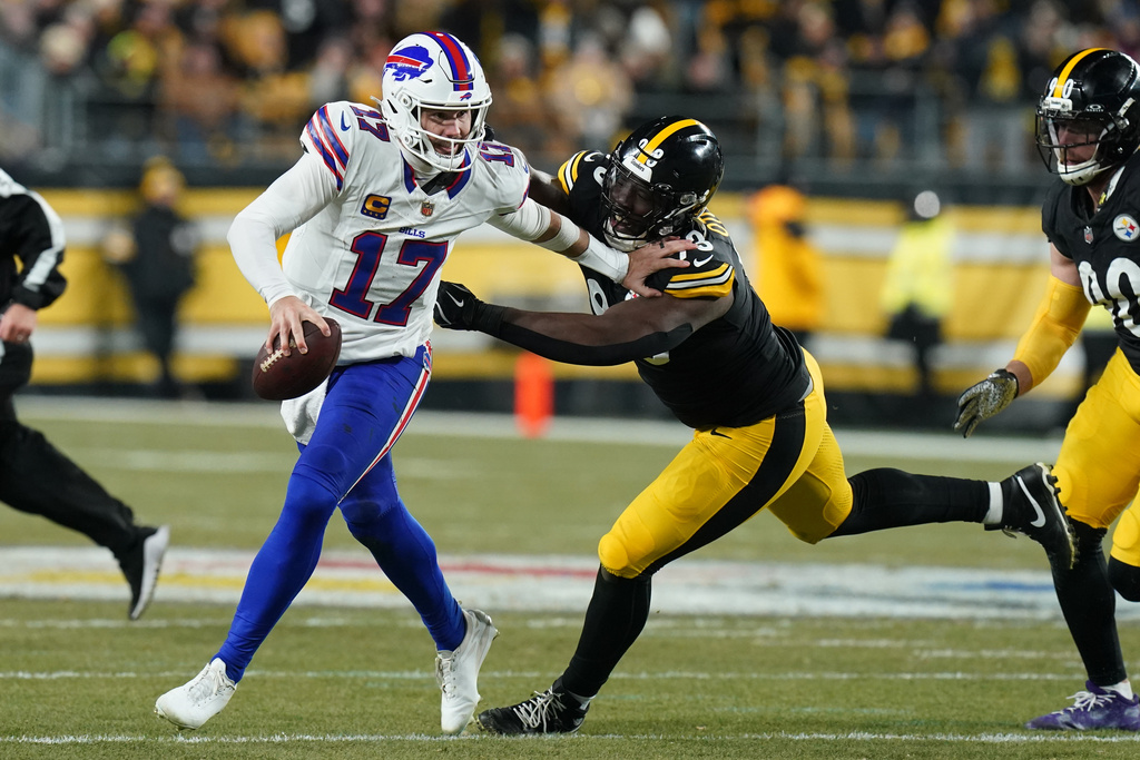 Buffalo Bills quarterback Josh Allen (17) is pressured by Pittsburgh Steelers cornerback Darius Slay (23) during the first half of an NFL football game Sunday, Nov. 30, 2025, in Pittsburgh. (AP Photo/Matt Freed)