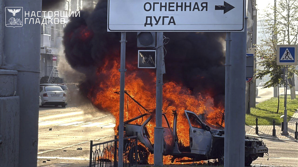 In this photo, released by Belgorod regional governor Vyacheslav Gladkov's Telegram channel on Thursday, Aug. 14, 2025, flames rise from a burning car in a street after a drone attack by the Armed Forces of Ukraine on the city of Belgorod. (Belgorod Region Governor Vyacheslav Gladkov Telegram channel via AP)